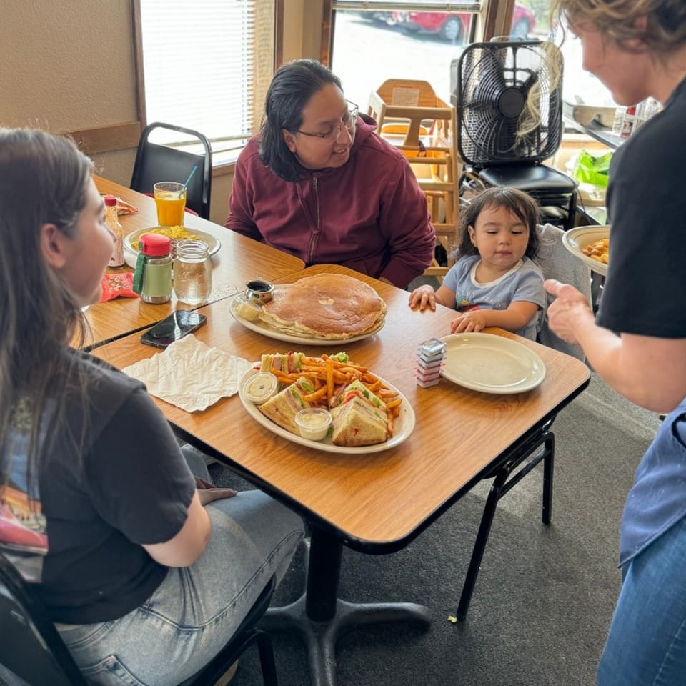 Family enjoying American breakfast and sandwiches at Mr T's Family Cafe.